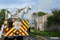 A tower ladder at the scene of an apartment fire