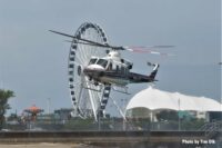 Helicopter with ferris wheel in background