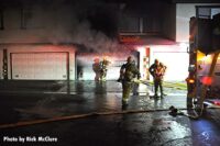 Firefighters work to gain access to a garage