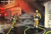 LAFD firefighters begin applying water to garage area