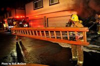 LAFD firefighters with a portable ladder