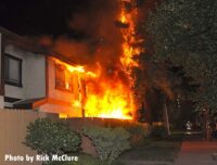 Fire vents from the building with a fence in the way