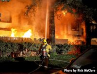 Firefighter applies an exterior hose stream