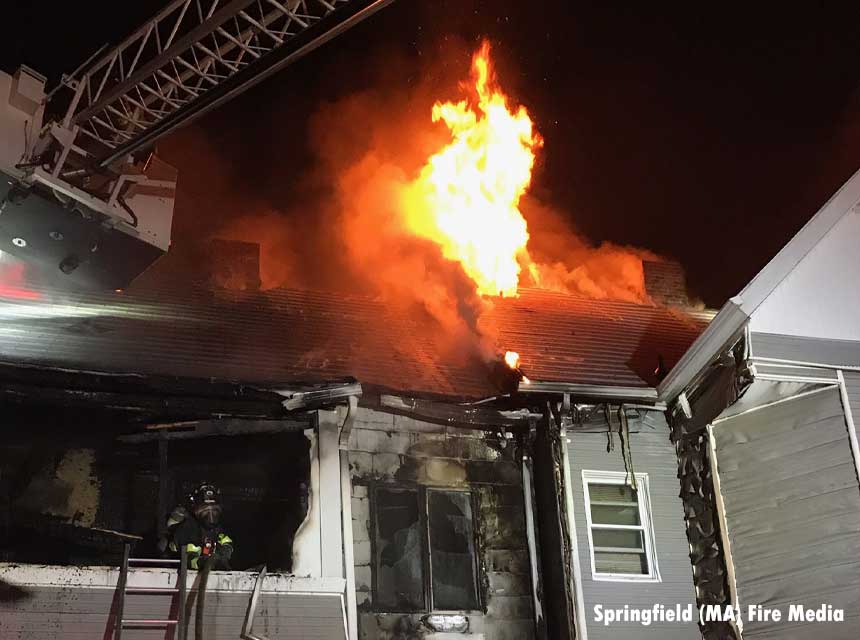 Firefighter with flames above him at Springfield fire