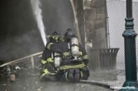 Firefighters on a hoseline at a commercial fire