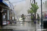 Ladders and firefighters outside a commercial occupancy in Uniondale