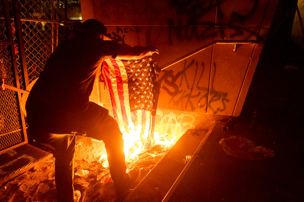 Protester burns U.S. flag in Portland