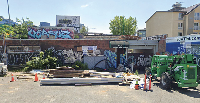 The building before the fire. Photo 2 shows the front exposure building and breezeway that need to be breached. Photo 3 is the B side. Photo 4 is the C side with the drop-off from the overpass. Photo 5 is an aerial view showing the building layout.