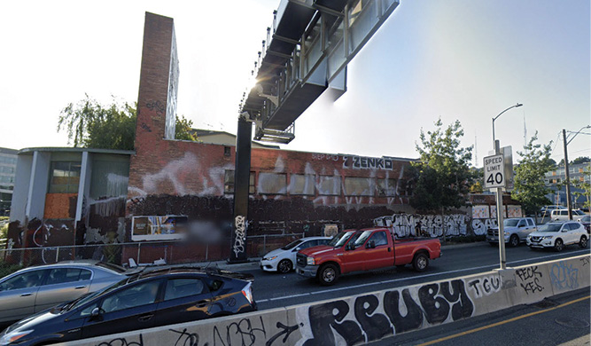 The building before the fire. Photo 2 shows the front exposure building and breezeway that need to be breached. Photo 3 is the B side. Photo 4 is the C side with the drop-off from the overpass. Photo 5 is an aerial view showing the building layout.