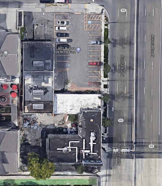 The building before the fire. Photo 2 shows the front exposure building and breezeway that need to be breached. Photo 3 is the B side. Photo 4 is the C side with the drop-off from the overpass. Photo 5 is an aerial view showing the building layout.