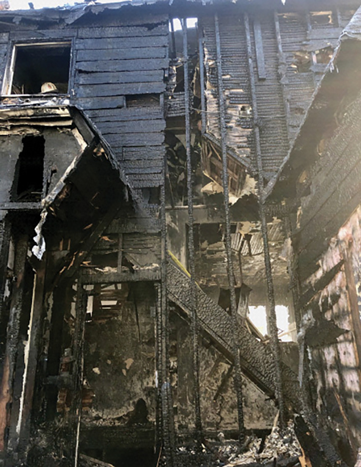 The exposure 2 side wall was parallel with the interior staircase. Once opened, the charred remains of 16-foot vertical wood studs that originated at the basement sill plate and extended upward into the eave line were discovered.