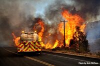 Fire apparatus fights wildland fire from road