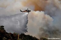 Helicopter drops fire retardant