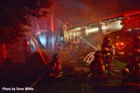 FDNY firefighter with hoselines in yard of home