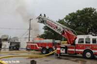 Firefighters in bucket operating at scene of fire