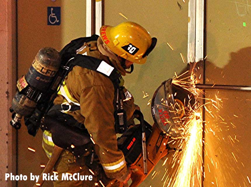 LAFD firefighter using a power saw