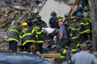 Baltimore City Fire Department carries a person rescued from blast