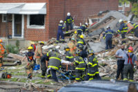 Baltimore City Fire Department carries a person out f