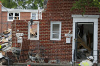 A firefighter walks near the debris