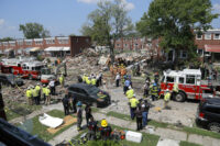 Rescue officials work near the rubble