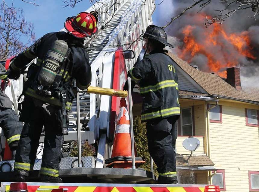 Firefighters stand on aerial device