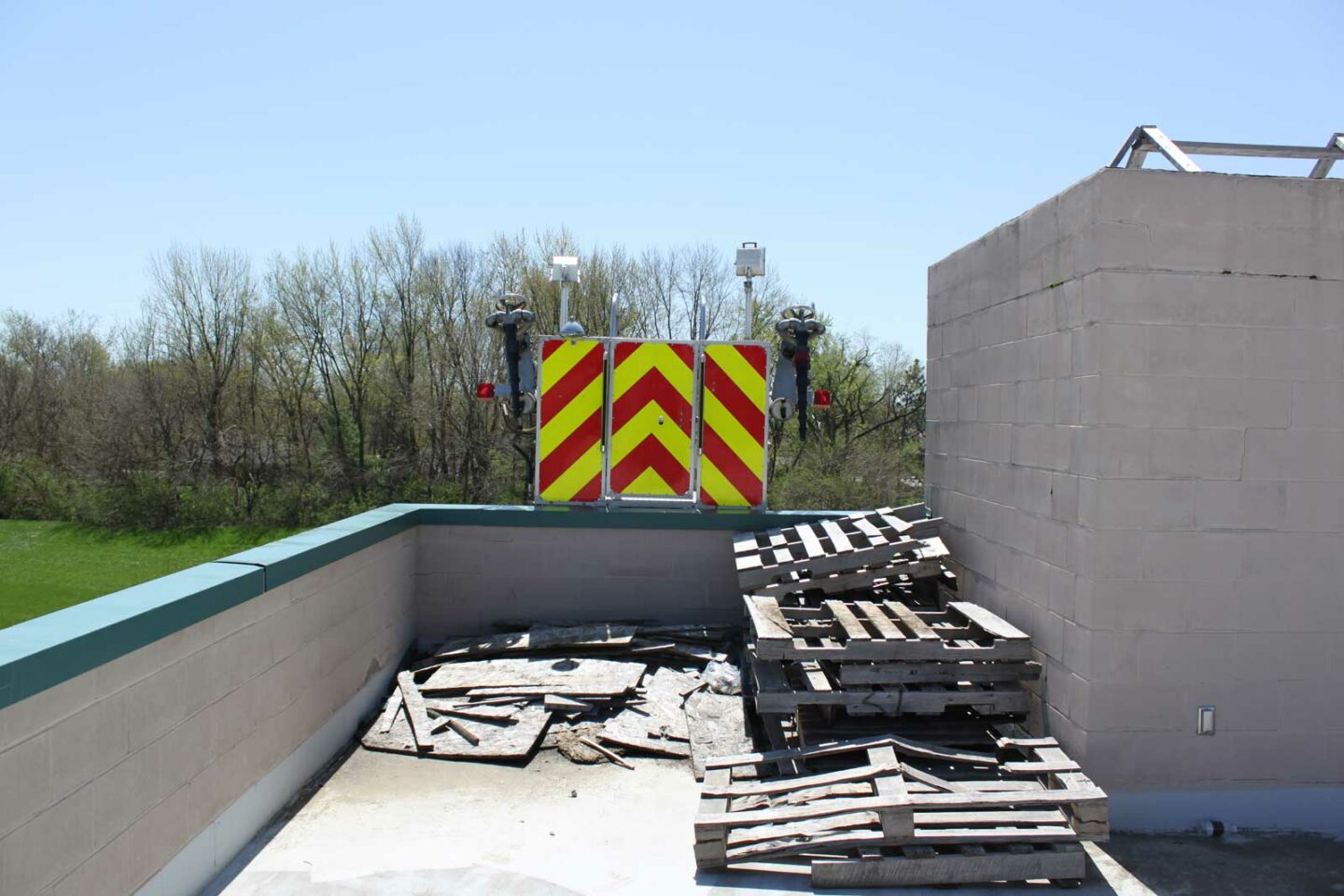 Tower ladder over flat roof with various debris