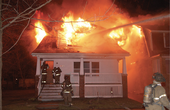 Flames erupt from a house fire