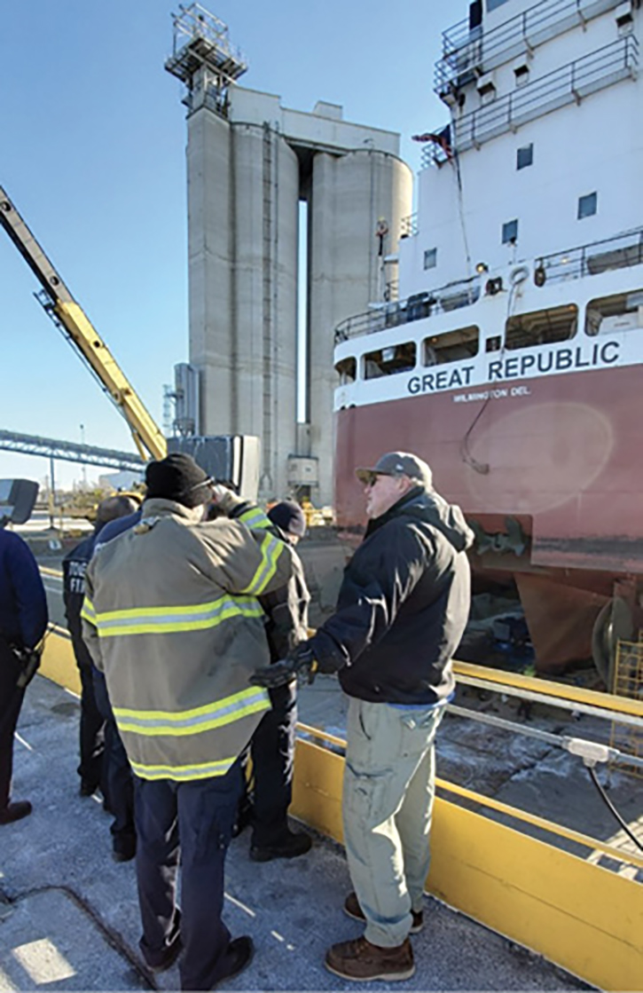 The superintendent of a shipyard welcomes rescuers as they begin a preplan of the facility, including a large freighter in dry dock.