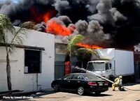 Flames shoot from a commercial building in Los Angeles