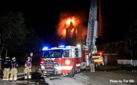 Fire truck with flames raging from church steeple