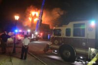 Fire trucks with flames erupting from a church