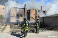 Firefighters at the scene of a fire that burned through multiple structures