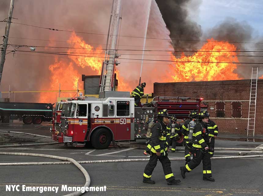 Members of the FDNY and rigs at Bronx junk yard fire