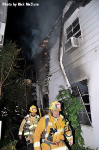 Firefighters at singed building in Los Angeles