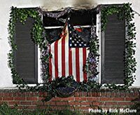 Photo of American flag hanging in window at house fire