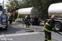 Firefighters with hoselines at the scene of the tanker incident