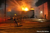 A firefighter at the scene of a raging fire in East L.A.