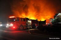 Fire apparatus with flames raging from the Bobcat Fire