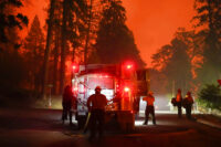 Firefighters stage near a Southern California Edison power station