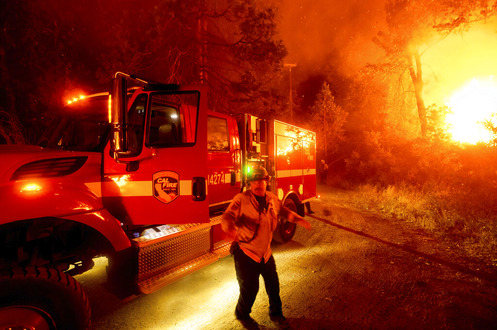 A firefighter battles the Creek Fire