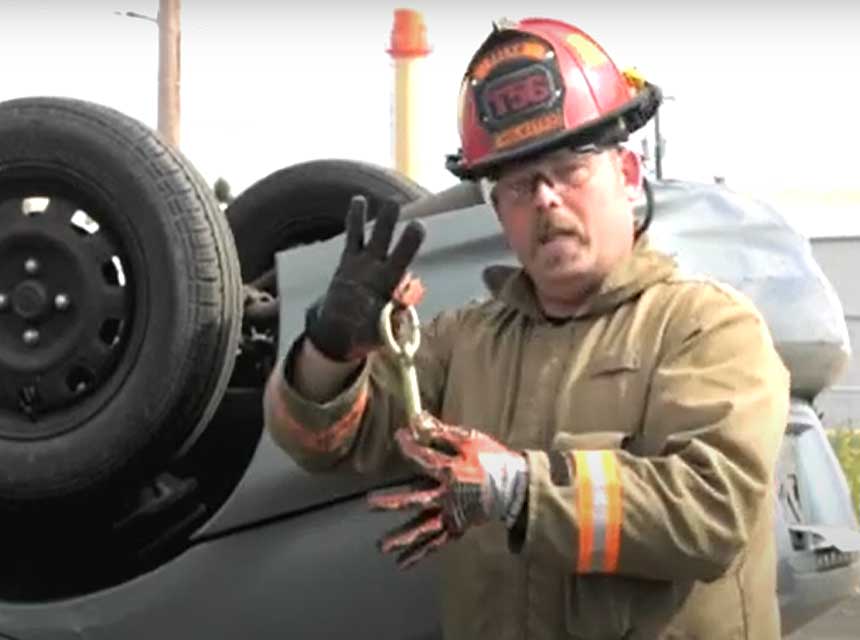 Firefighter Chris Mills with overturned vehicle