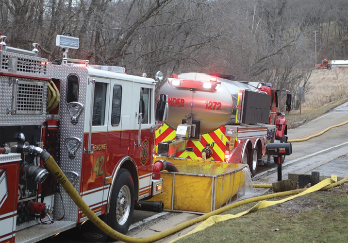 The first-arriving tender established a nursing operation on the roadway in front of the fire scene.