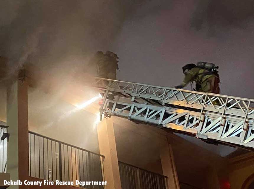 Firefighters on an aerial ladder at a hotel fire