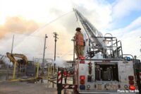 Firefighter on aerial with master stream