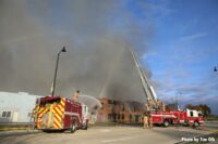 Two apparatus blasting water into abandoned Rockland building