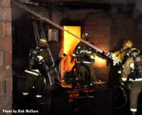 Firefighter on the line applying exterior stream