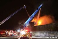 Firefighters with two aerials conducting water operations at fire