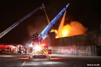 Flames and elevated water streams at building