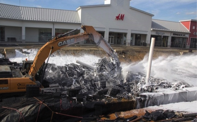 Track hoe operations that broke up drainage system components during foam application.