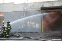 FDNY firefighters with a hose stream